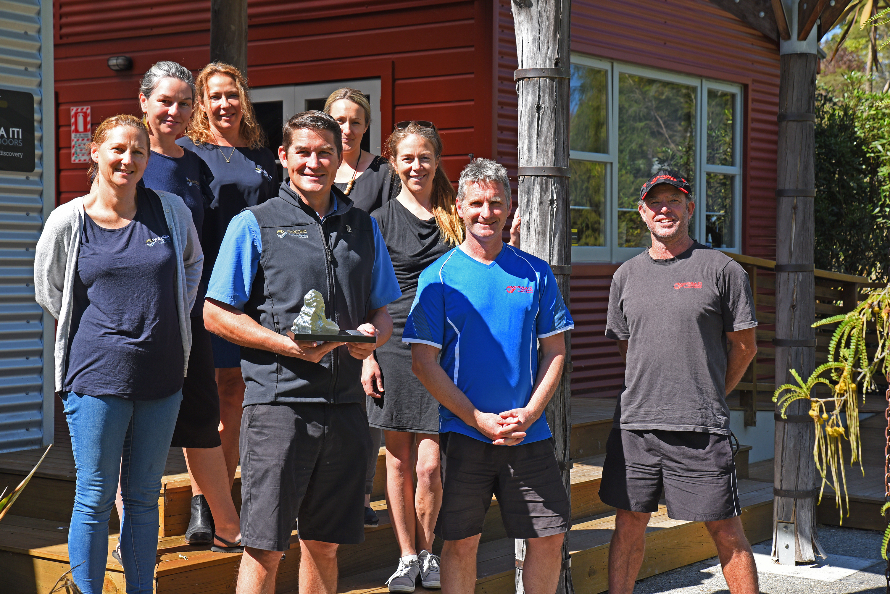 Whenua Iti team members with business award