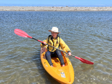 student paddling a kayak