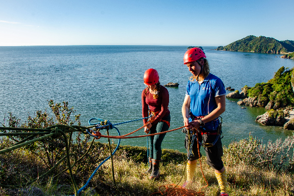 student at the top of an abseil roped up