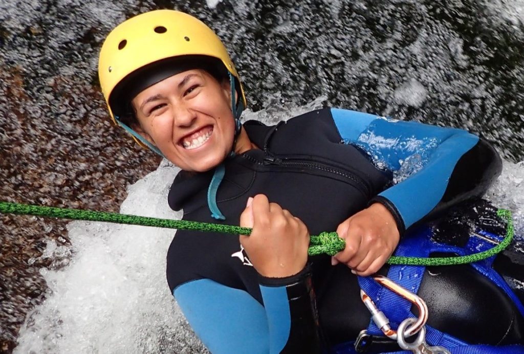 Trainee instructor Taylor smiles while canyoning