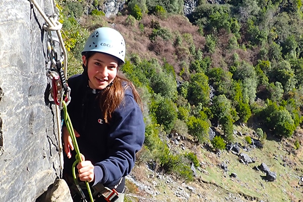 young woman rockclimbing