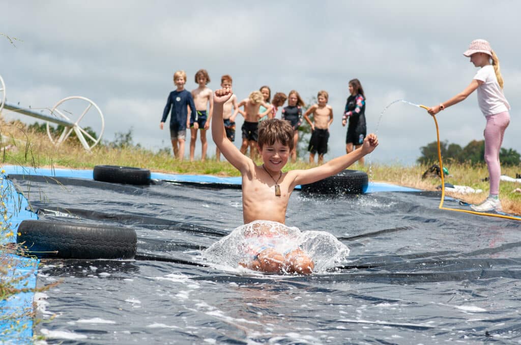 Boy smiling on a waterslide