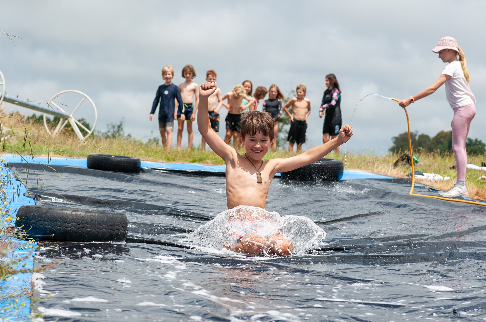 Boy smiling on a waterslide